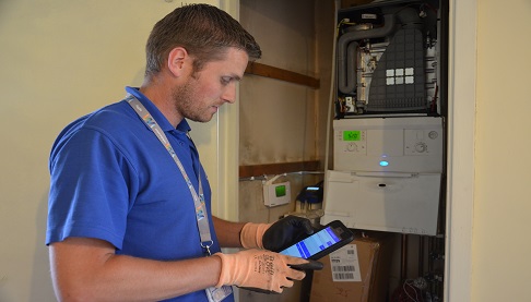 Heating engineer looking at boiler