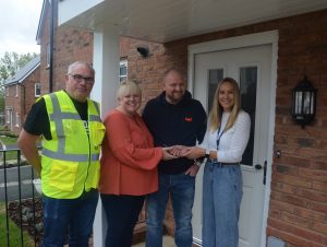 Tenants receiving the keys to their home