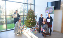 Two Rivers Housing colleagues hold presents with Major Vivienne Prescott