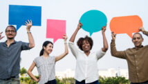 Diverse group of people holding up speech bubbles