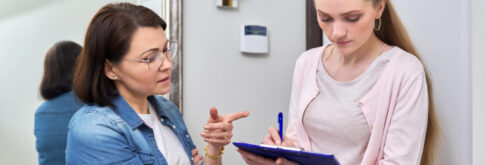 Female worker collecting census data from a tenant