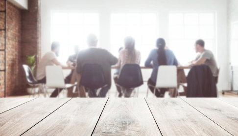 Diverse group of people sat in a Boardroom having a meeting.