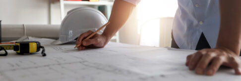 Close up of a person looking over plans for development