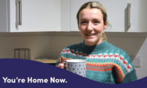 Hannah in her new kitchen with a cup of tea.