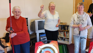 Home Plus tenants playing indoor archery game